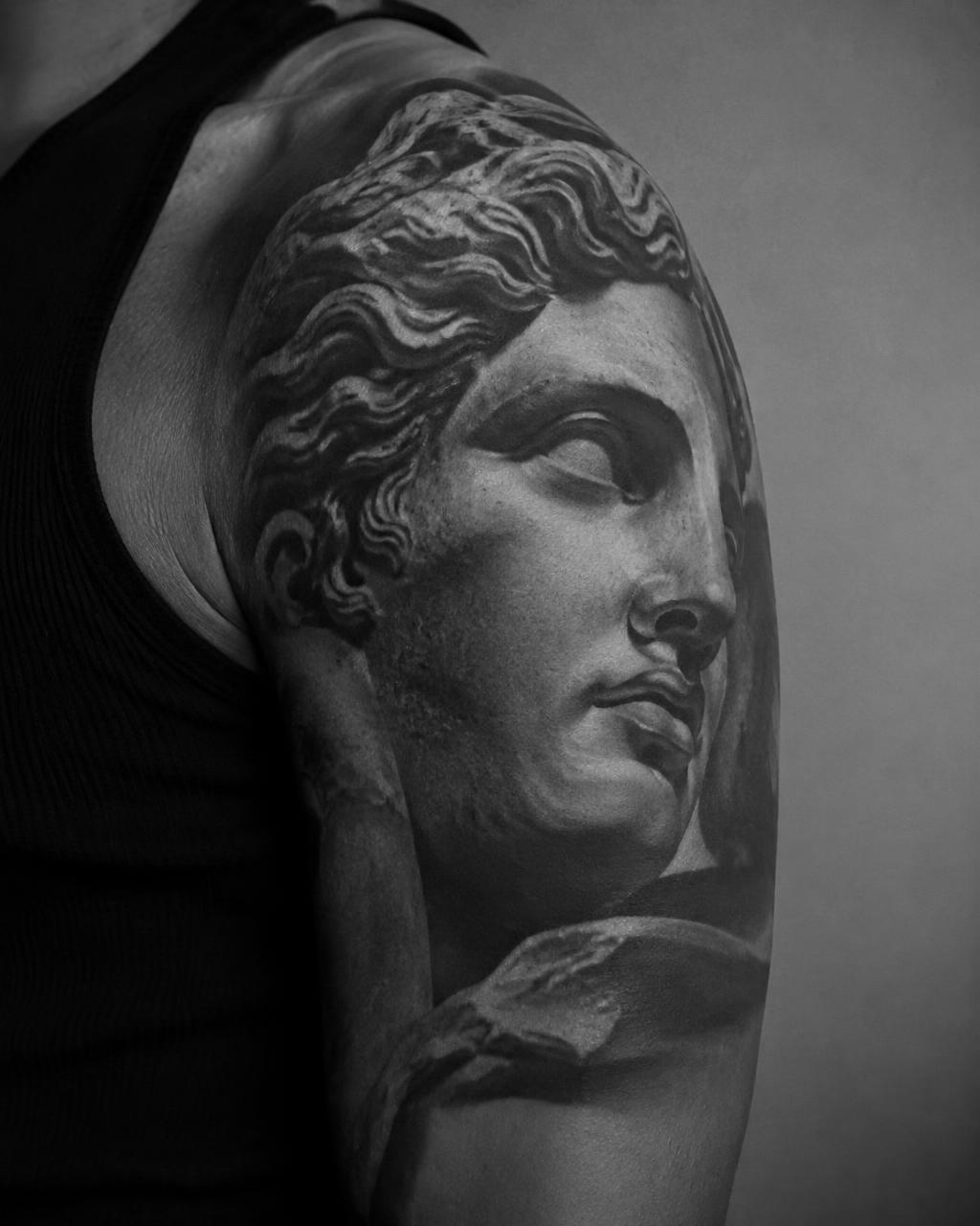 Black and grey realism — classical statue on shoulder